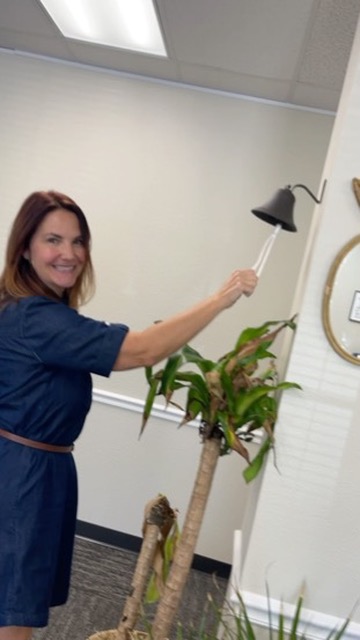 A Benefits Boss advisor ringing the celebration bell in the office