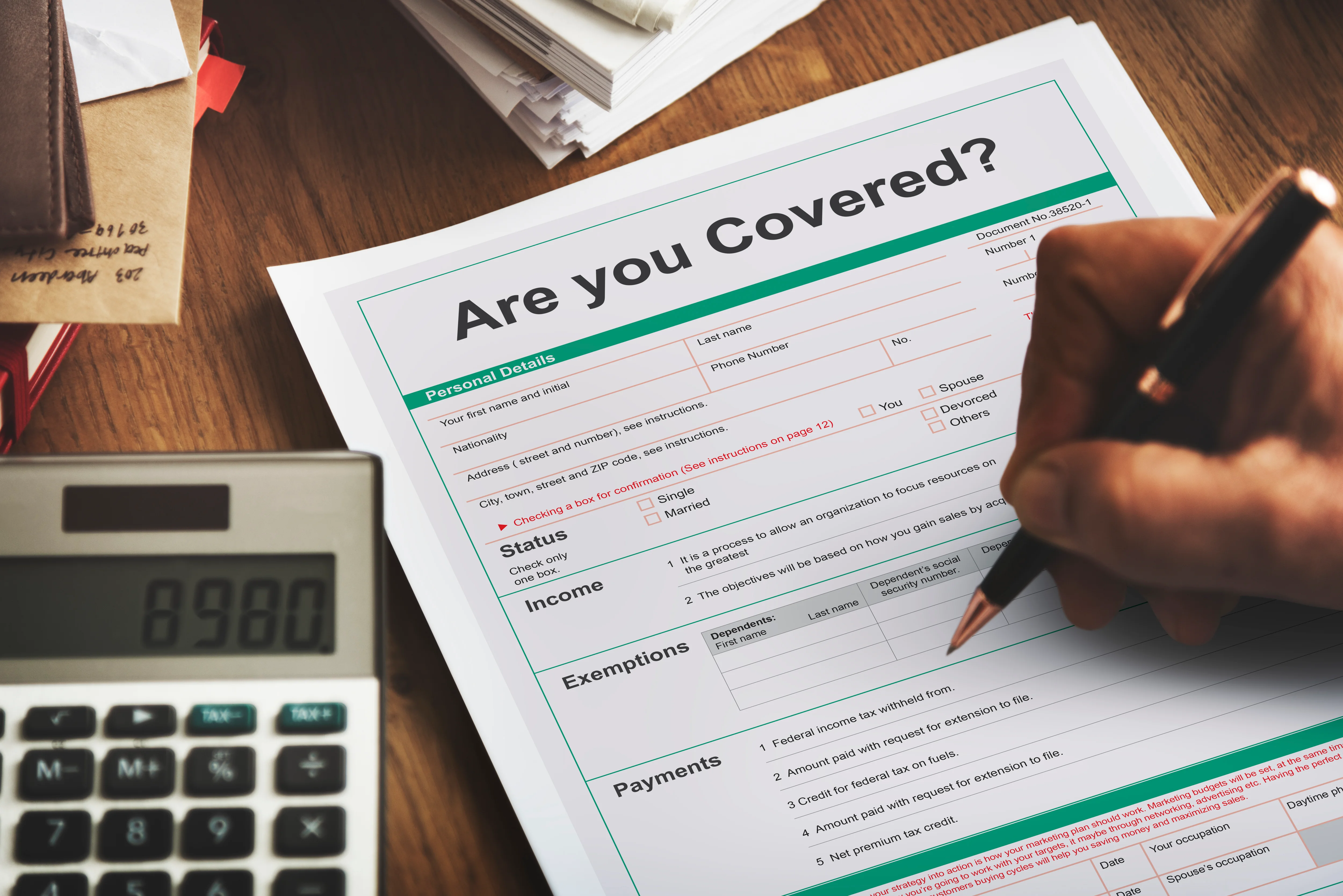 are you covered health insurance paper on desk with person signing paper