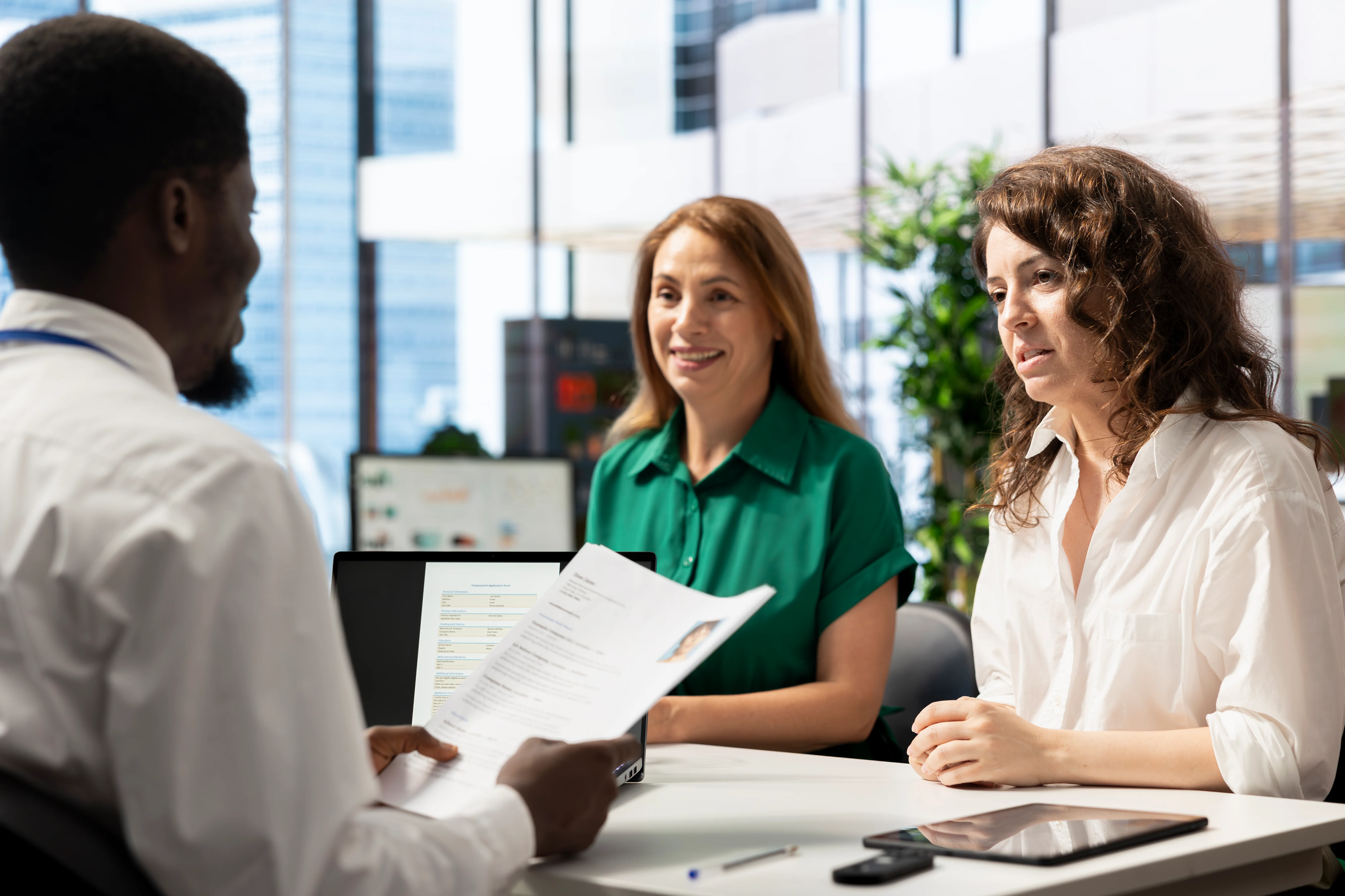 cheerful private insurance brokers asking questions to clients