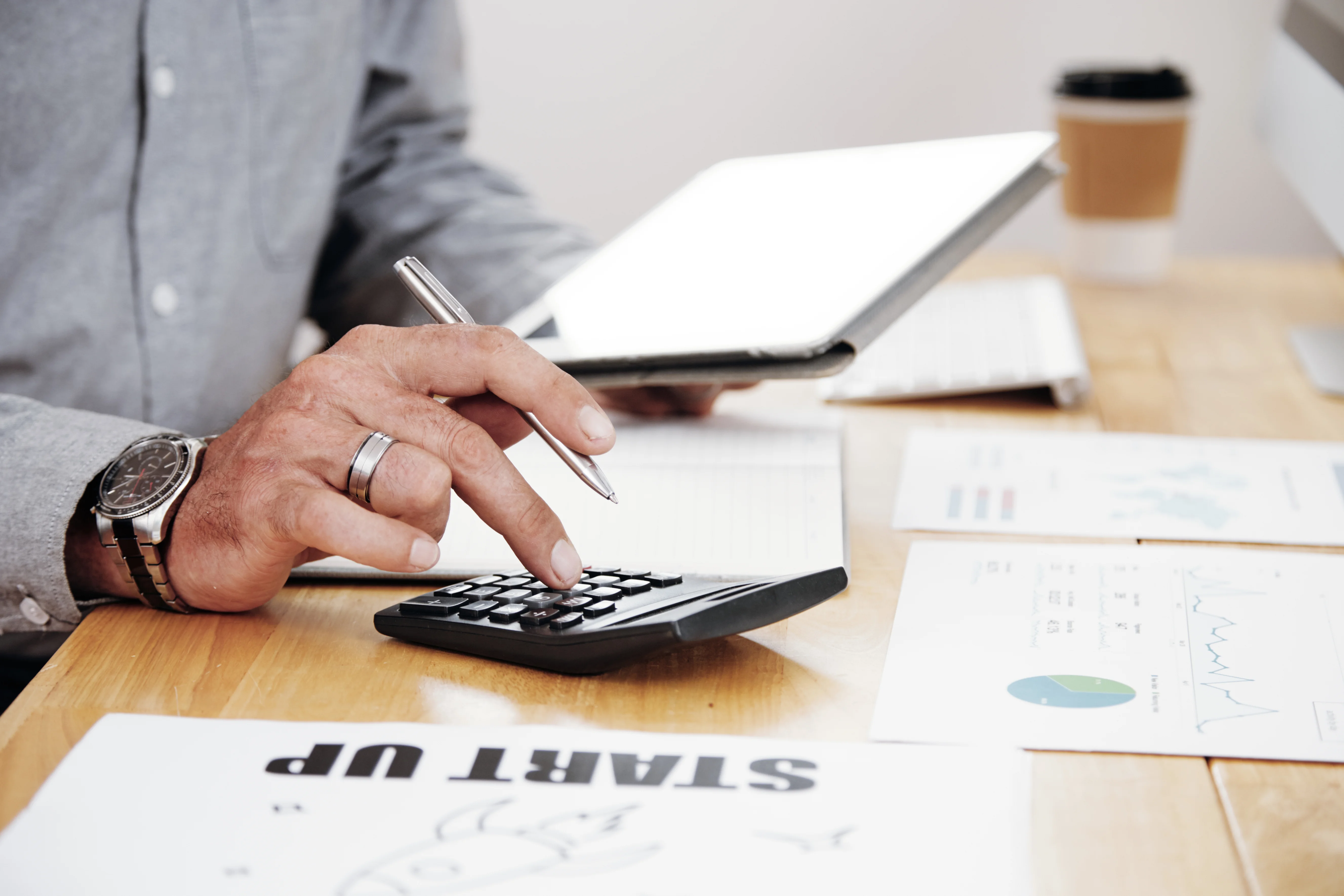 Financial professional using a calculator to review cost of switching health care plans
