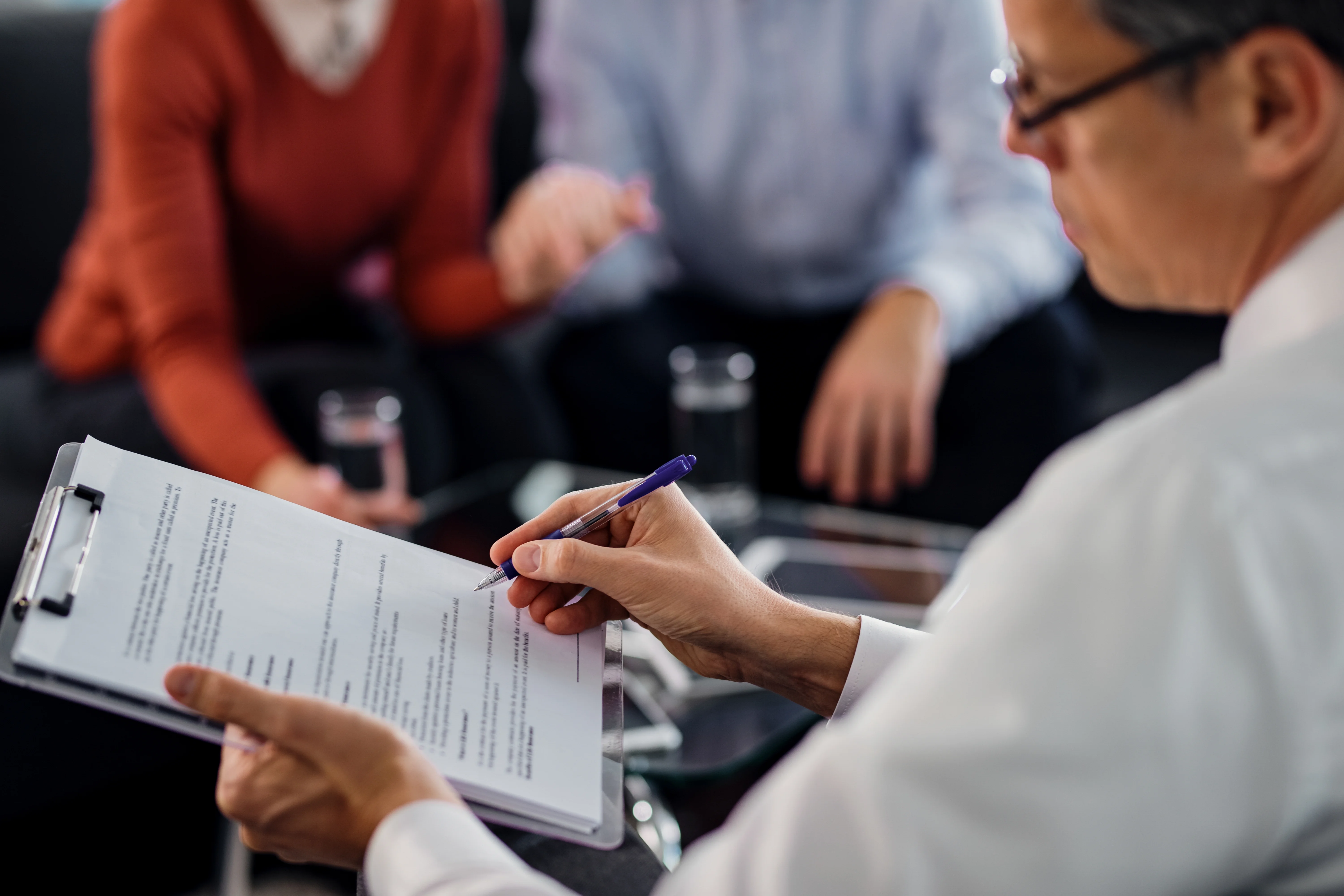 Insurance advisor reviewing paperwork during a client consultation about private health insurance options