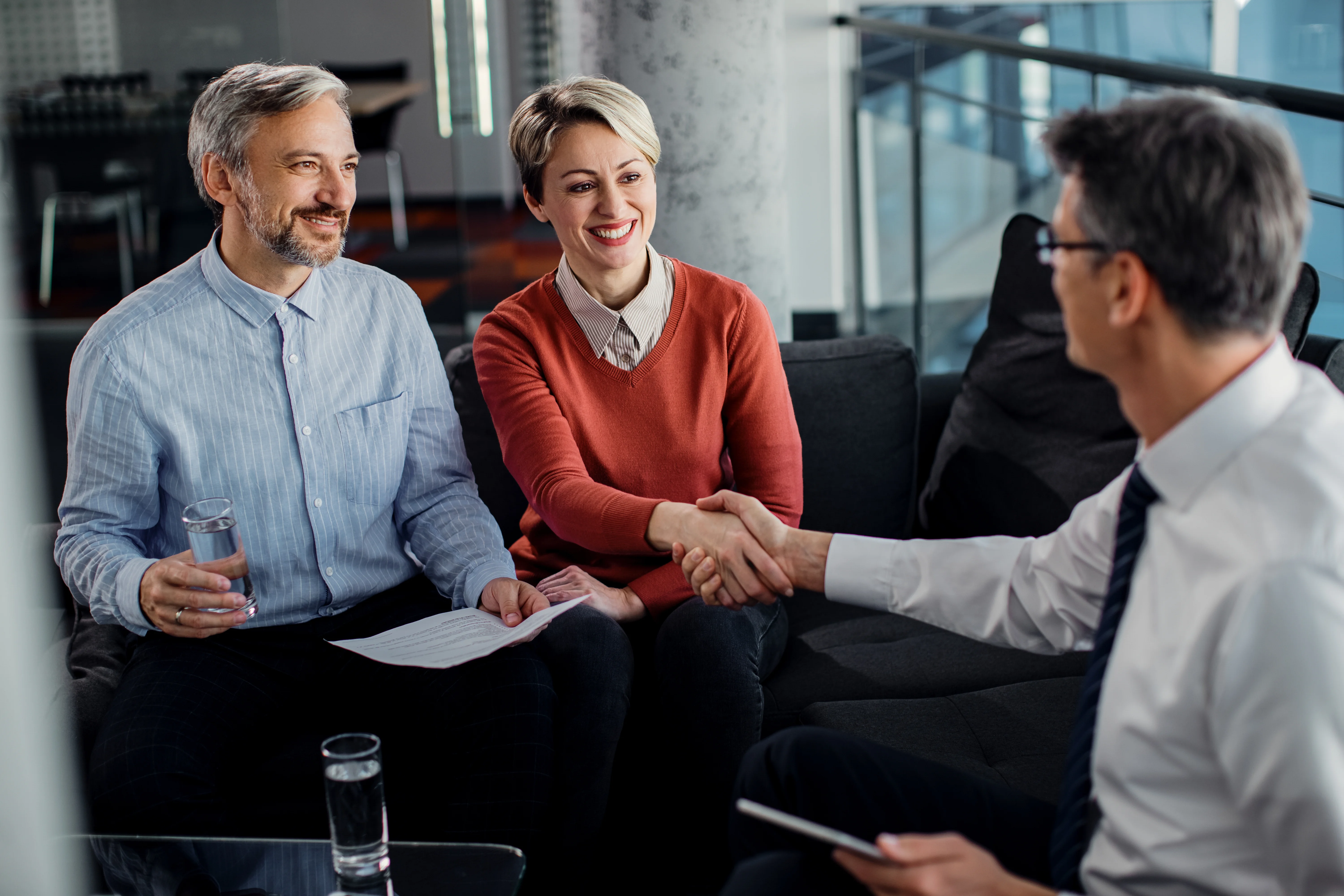 Insurance advisors reassuring unemployed man on health coverage options