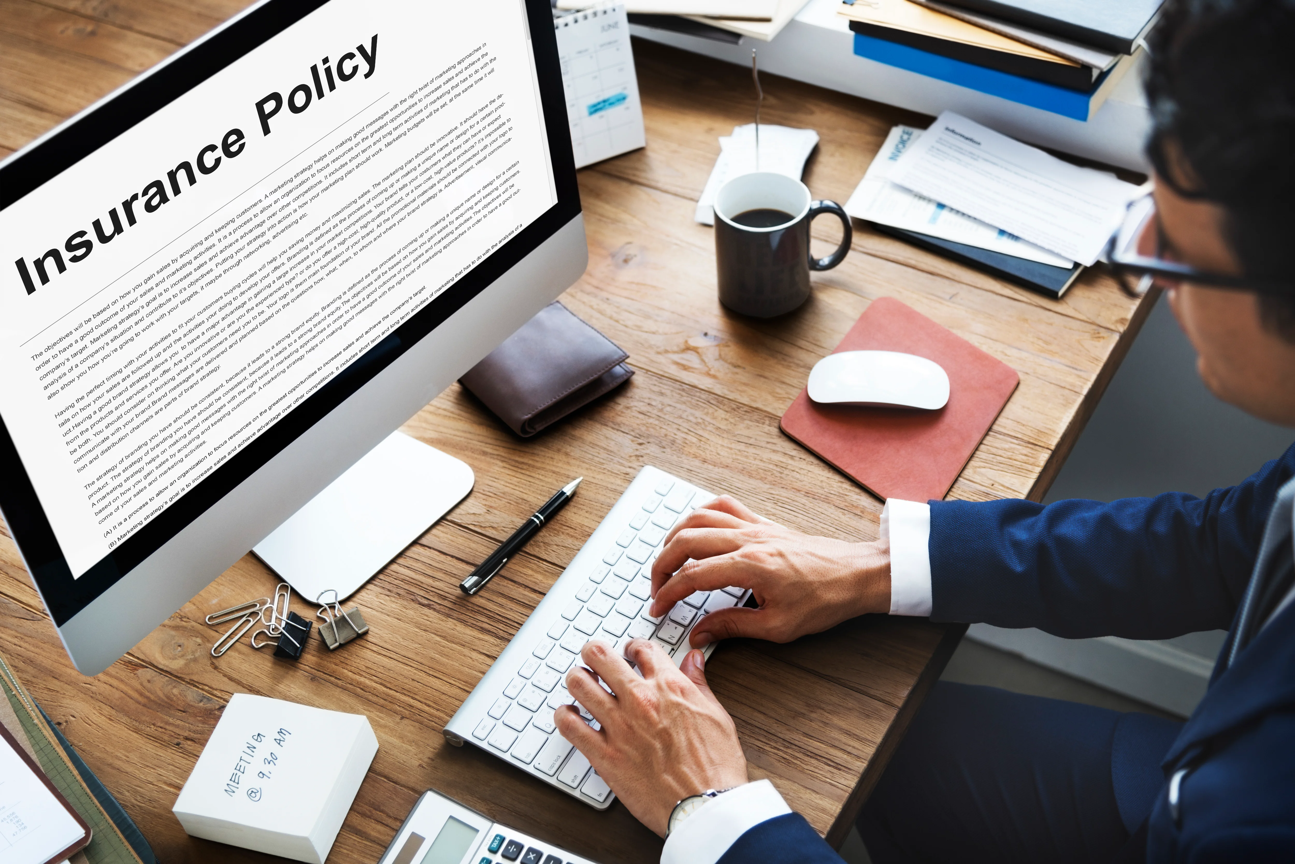 Man reviewing health insurance policy details on a computer