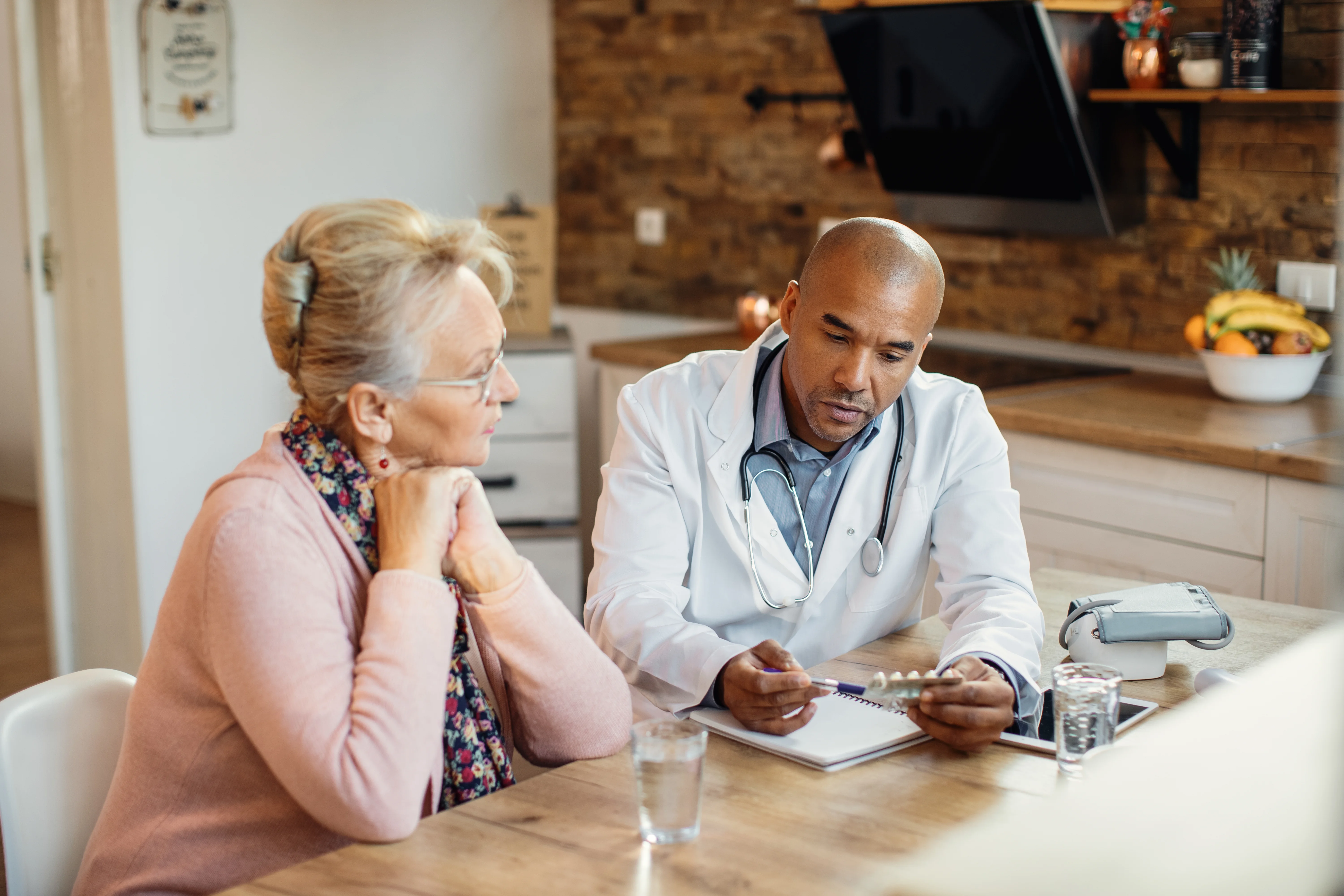 private medical insurance broker discussing options with mature woman